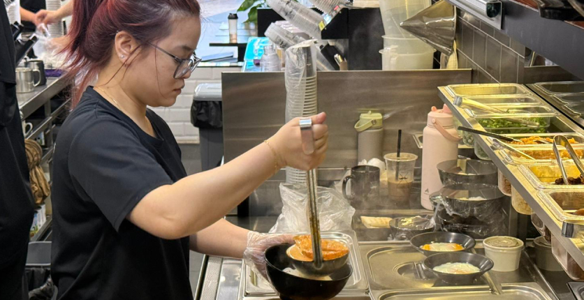 Kopifellas staff cooking laksa