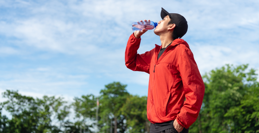 Man drinking water outdoors