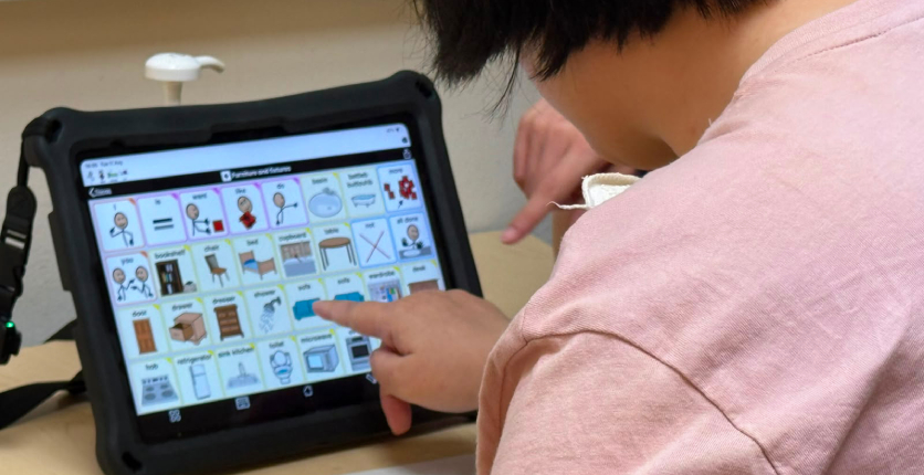 Yee Hua using her AAC iPad